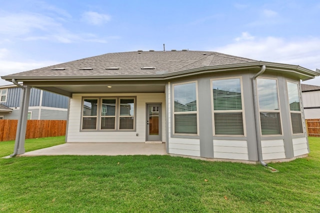 rear view of house with a patio area and a yard