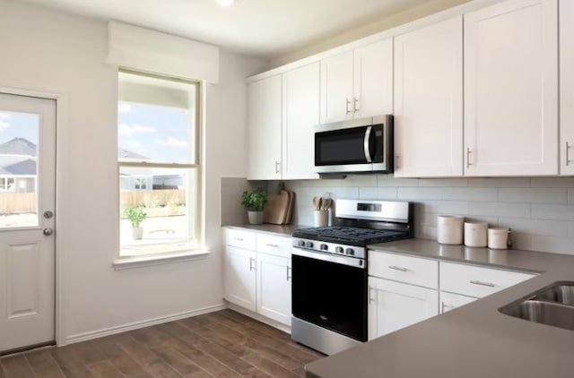 kitchen with appliances with stainless steel finishes and white cabinetry