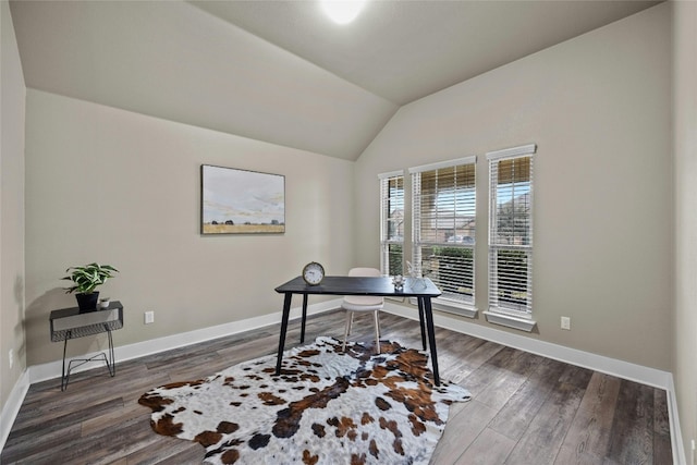 home office with dark wood-type flooring and vaulted ceiling