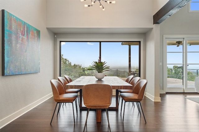 dining space featuring dark wood-type flooring, beamed ceiling, and a notable chandelier