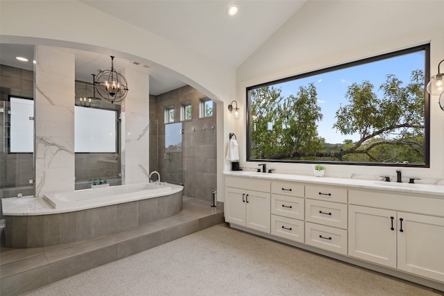 bathroom with vanity, shower with separate bathtub, a wealth of natural light, and lofted ceiling