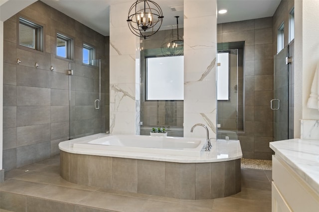 bathroom featuring tile walls, a notable chandelier, vanity, and plus walk in shower