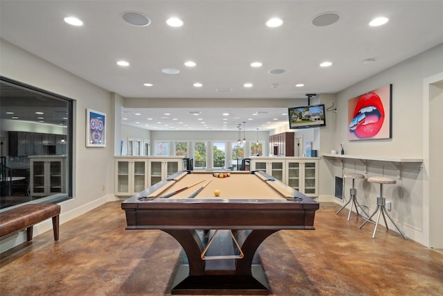 rec room featuring billiards, bar, and concrete flooring