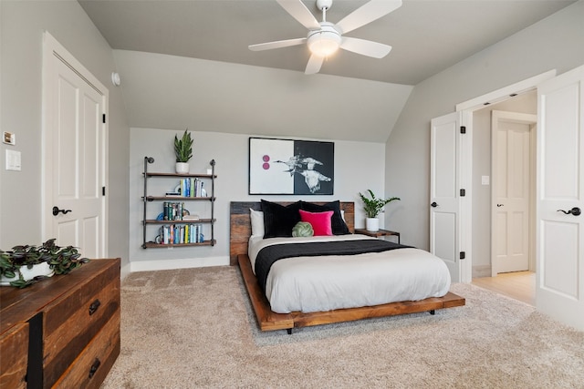 bedroom with ceiling fan, lofted ceiling, and light colored carpet