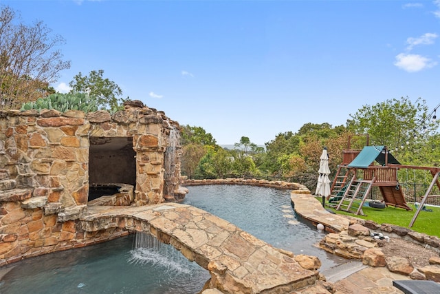 view of swimming pool featuring a playground and pool water feature