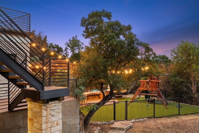 view of yard featuring fence and a playground