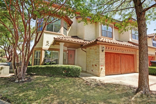 7800 SW Pkwy Unit 510, Austin, TX 78735 - mediterranean / spanish home with an attached garage, a tile roof, stucco siding, driveway, and stone siding