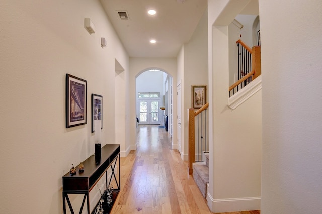 hall featuring french doors and light wood-type flooring