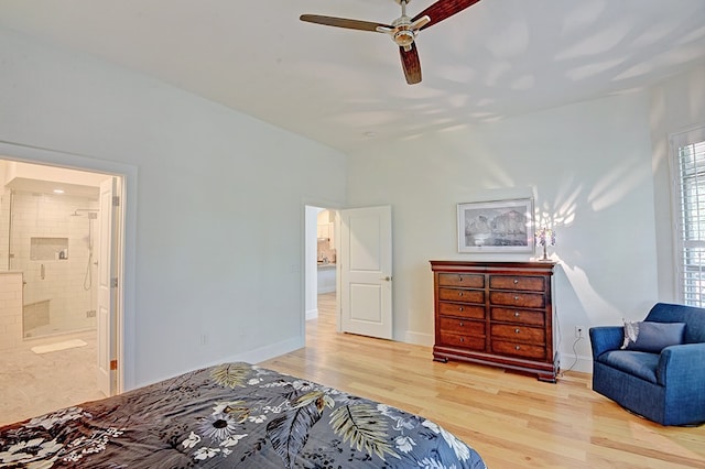 bedroom featuring light wood-type flooring, ceiling fan, and connected bathroom