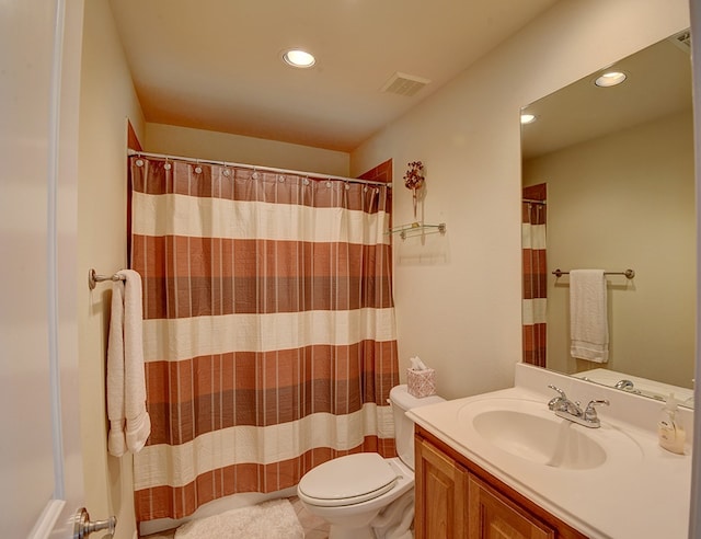 bathroom with walk in shower, tile patterned flooring, vanity, and toilet