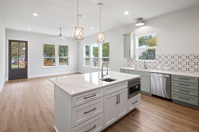 kitchen with sink, stainless steel appliances, and a healthy amount of sunlight