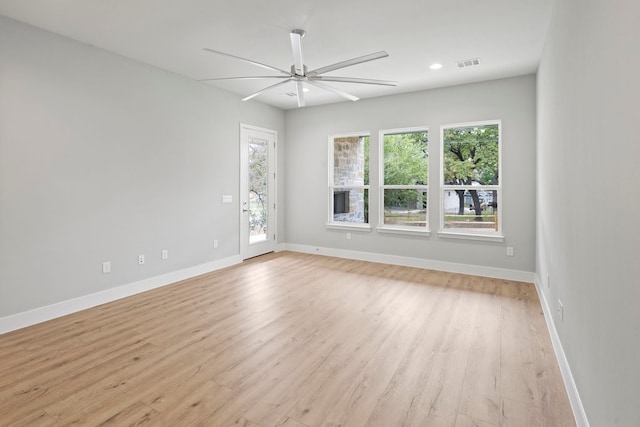 unfurnished room featuring light hardwood / wood-style floors, a wealth of natural light, and ceiling fan