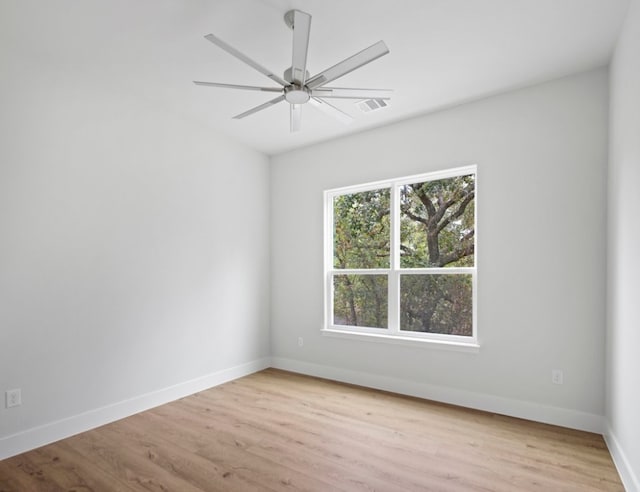 spare room with light hardwood / wood-style flooring and ceiling fan