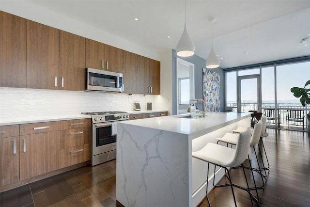 kitchen with stainless steel appliances, decorative backsplash, sink, and dark hardwood / wood-style floors