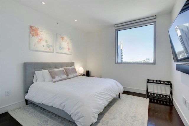 bedroom with dark hardwood / wood-style floors