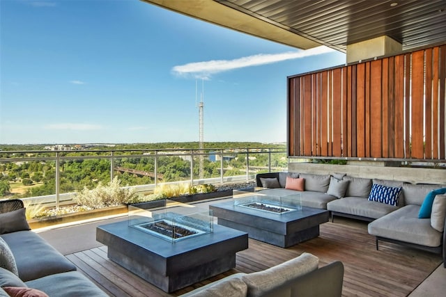 exterior space featuring an outdoor living space with a fire pit