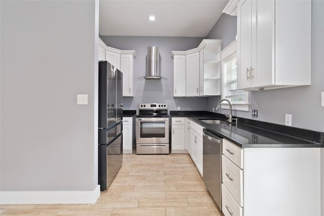 kitchen with sink, white cabinetry, wall chimney range hood, and stainless steel appliances