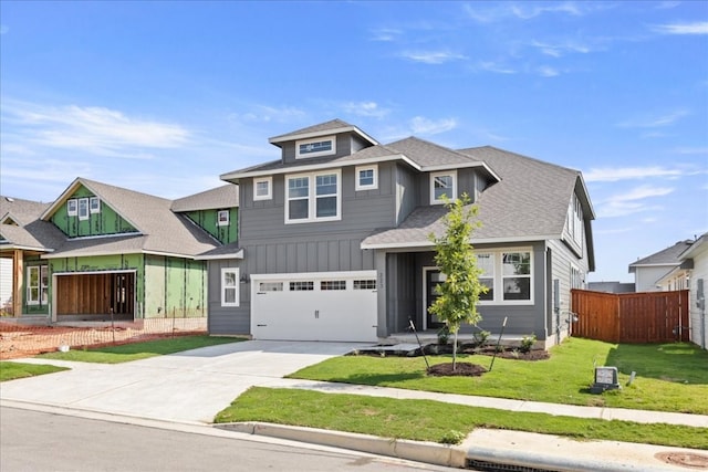 view of front of property with a front yard and a garage