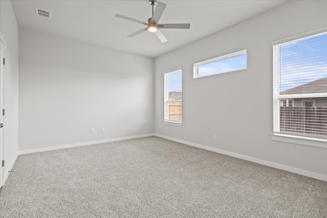 carpeted spare room with ceiling fan