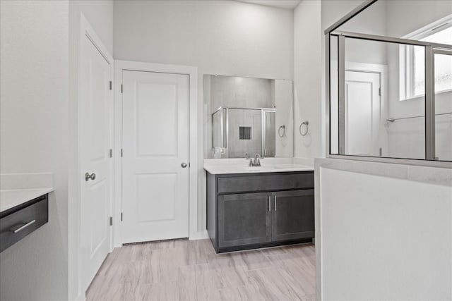 bathroom featuring vanity and a shower with shower door