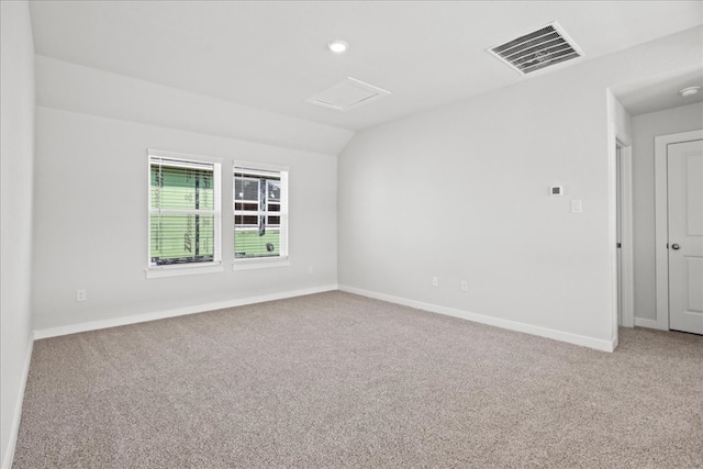 unfurnished room featuring carpet and vaulted ceiling