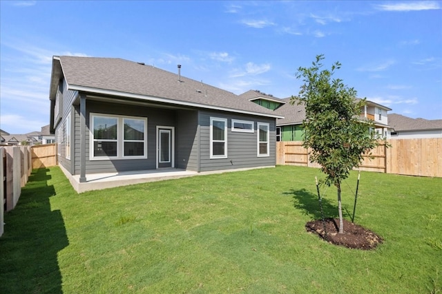 back of house featuring a patio and a lawn