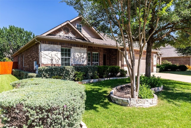 view of front of house featuring a front lawn and a garage