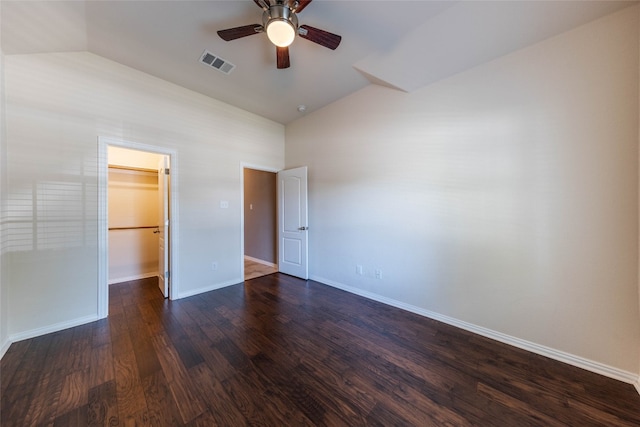 unfurnished bedroom with dark hardwood / wood-style floors, a closet, a spacious closet, high vaulted ceiling, and ceiling fan