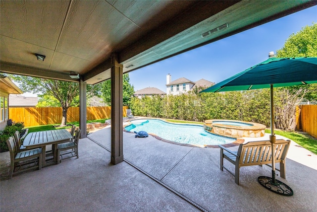 view of pool with an in ground hot tub and a patio