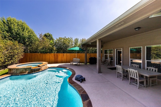 view of pool featuring an in ground hot tub and a patio