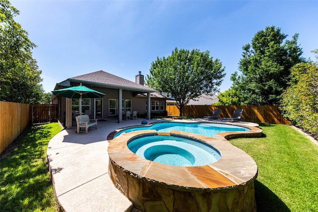 view of pool featuring a patio, an in ground hot tub, and a lawn