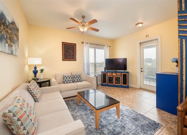 tiled living room with ceiling fan