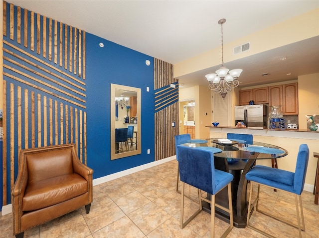 dining area featuring a chandelier and light tile patterned floors