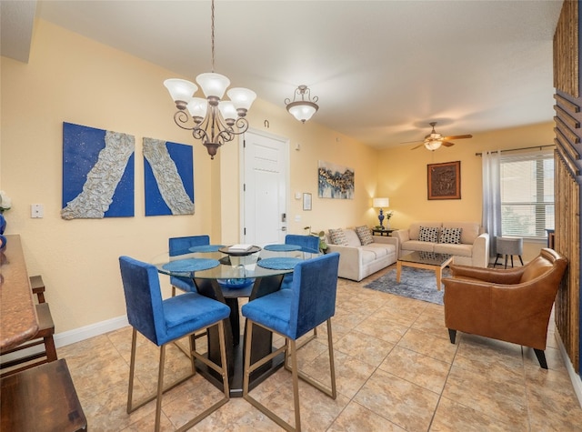 dining room featuring ceiling fan with notable chandelier and light tile patterned floors