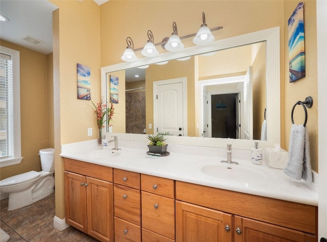 bathroom featuring vanity, toilet, a shower, and tile patterned flooring