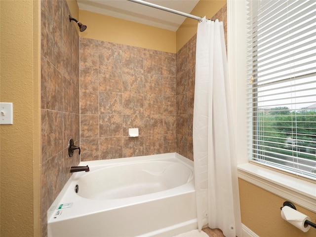 bathroom with shower / bath combo with shower curtain