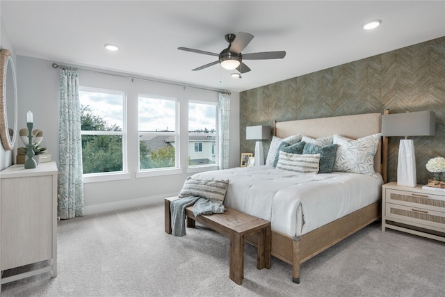 bedroom featuring light colored carpet and ceiling fan