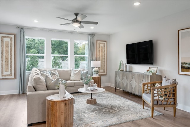 living room featuring wood-type flooring and ceiling fan