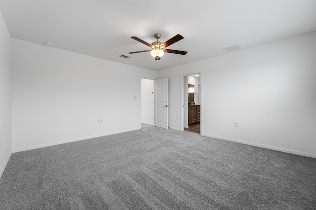 unfurnished bedroom featuring carpet floors, baseboards, a ceiling fan, and visible vents