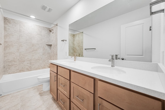 full bathroom featuring double vanity, a sink, shower / bathing tub combination, and toilet