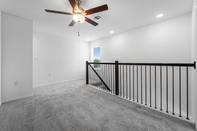 carpeted spare room featuring a ceiling fan, baseboards, visible vents, and recessed lighting