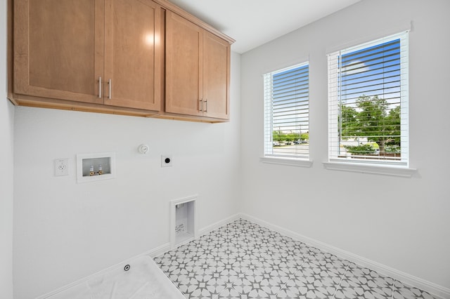 laundry area featuring baseboards, hookup for a washing machine, gas dryer hookup, cabinet space, and hookup for an electric dryer