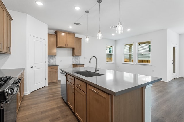 kitchen with brown cabinetry, a sink, dark wood finished floors, and gas range