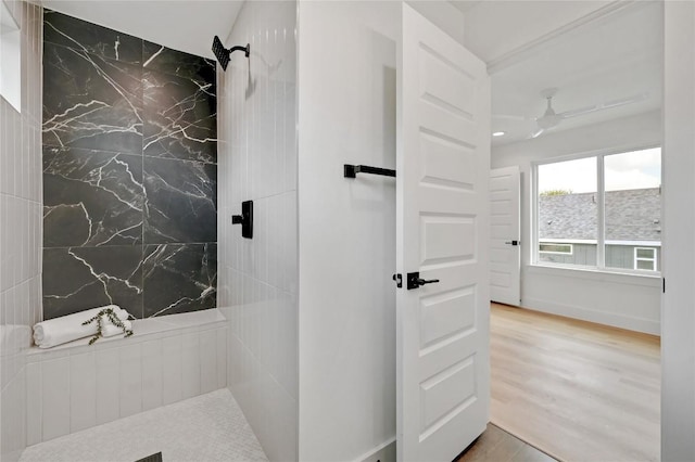 bathroom featuring a tile shower, ceiling fan, and hardwood / wood-style flooring