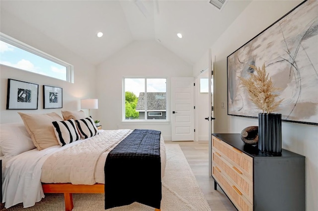 bedroom featuring light hardwood / wood-style flooring and lofted ceiling