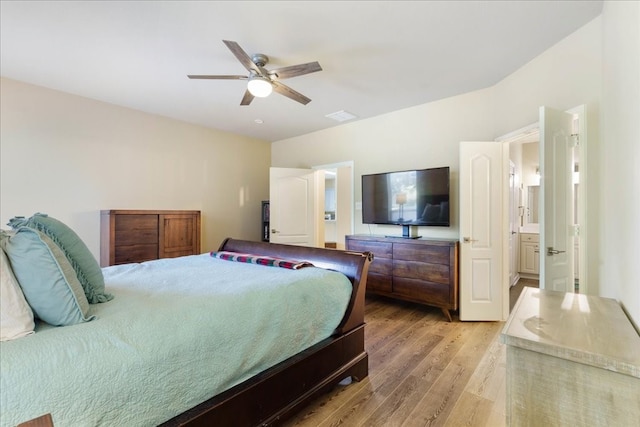 bedroom featuring ensuite bathroom, light wood-type flooring, and ceiling fan