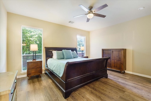 bedroom with hardwood / wood-style floors and ceiling fan