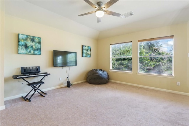 interior space with light carpet and ceiling fan