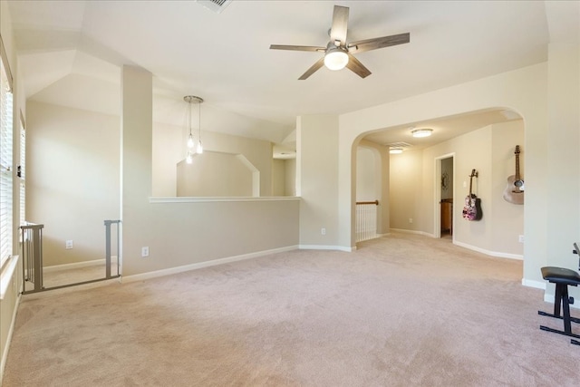 empty room with light carpet, lofted ceiling, and ceiling fan