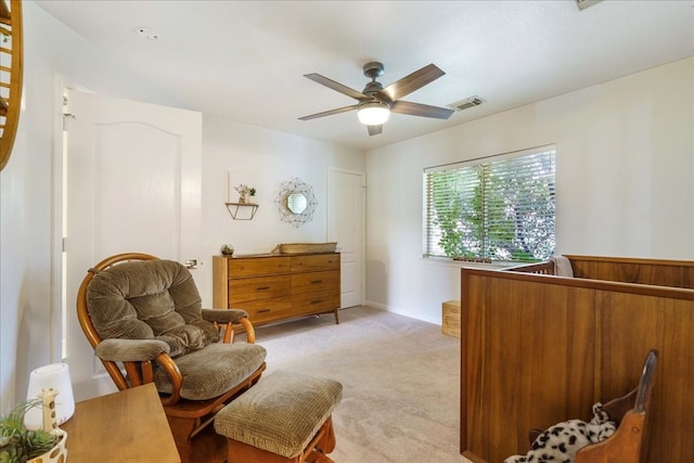 living area with ceiling fan and light colored carpet